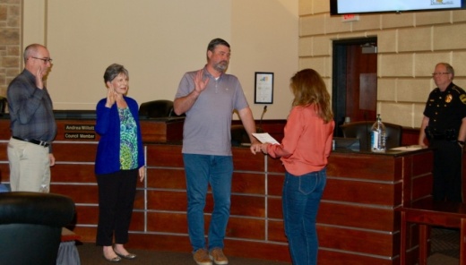 City Secretary Kaylynn Holloway (right) conducts the oath of office May 11 to City Council members, from left: Kevin Hight, Andrea Willott and Andrew Clark. (Greg Perliski/Community Impact Newspaper)