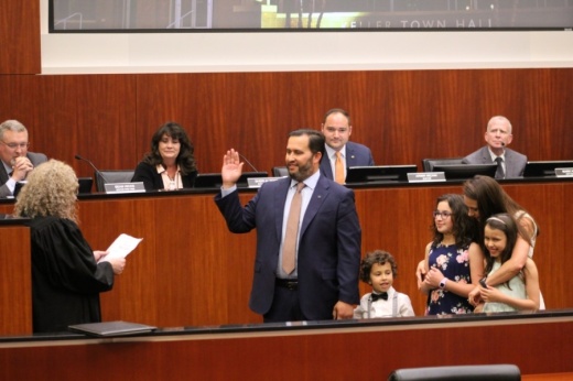 Shannon Dubberly raises his hand in front of a judge while being sworn in