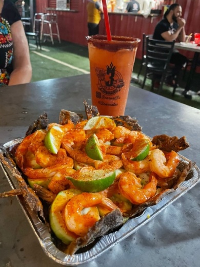 The business offers drive-thru service with micheladas, snacks, fountain drinks, and draft and bottle beers as well as food trucks. (Courtesy Tres Carnales)