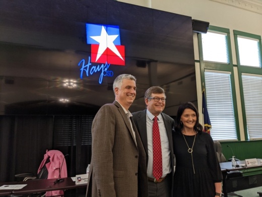 Hays CISD At-Large Trustee Will McManus (left), Hays County Precinct 2 Commissioner Mark Jones (center) and Hays CISD District 3 Trustee Courtney Runkle (right) stand for a photo during a May 17 meeting. (Warren Brown/Community Impact Newspaper)
