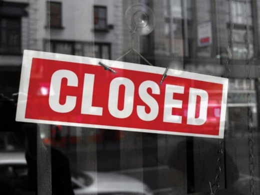 red closed sign in glass door