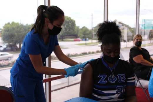 A woman receives a coronavirus vaccine at a vaccination event in Houston. (Shawn Arrajj/Community Impact Newspaper)