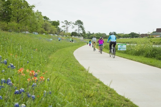 Residents bike along the Brays Bayou Greenway Trail in Houston. (Courtesy Houston Parks Board)