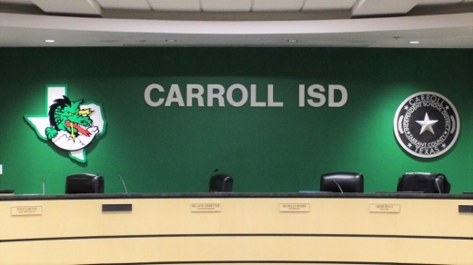 an empty dais for the Carroll ISD board of trustees