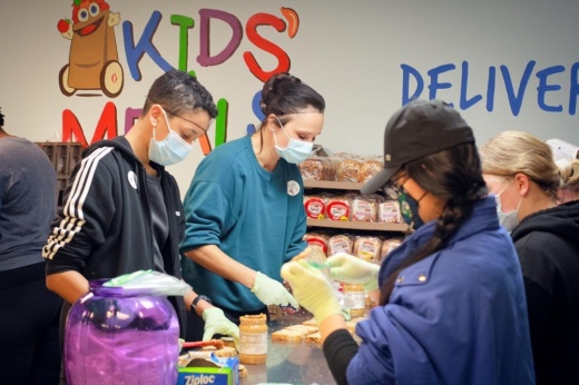 Volunteers at Kids Meals Inc. in the Garden Oaks area help put together meals and grocery bags for families in need. (Courtesy Kids Meals Inc.)