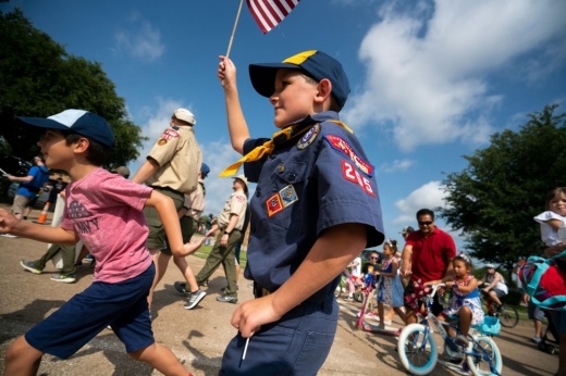 Boy Scout with flag in parade