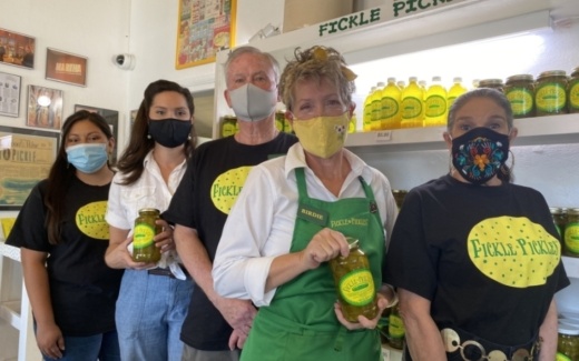 Staff members at Fickle Pickles help customers with in-store or online purchases. (Photos by Brian Rash/Community Impact Newspaper)