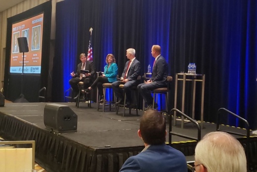 Tony Felker, Frisco Chamber of Commerce president and CEO (far left), interviews a panel of Frisco leaders during the 2021 State of the City Luncheon. (Miranda Jaimes/Community Impact Newspaper)