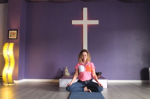 Cass Gibson has a cross in her yoga studio as a part of her promise to God, she said, but practices are not centered around any one religion; Gibson believes "everyone needs a source" for spiritual guidance. (Colleen Ferguson/Community Impact Newspaper)