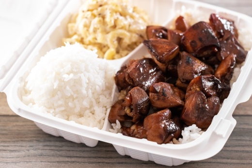 A to-go box with Huli Huli Chicken, rice, and macaroni and cheese
