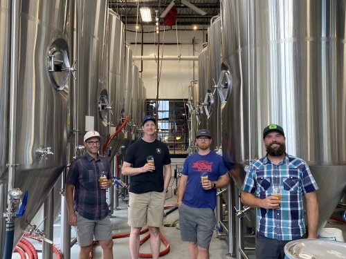 From left to right stand co-founders Tyler Norwood, Ned Lavelle, Kyle Detrick and Joe Mohrfeld inside the brewery of the Round Rock location. Not pictured are co-founders Ryan Van Biene and Nic Van Biene.