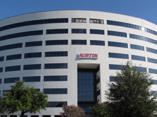 The front of a large white building for Austin ISD. 