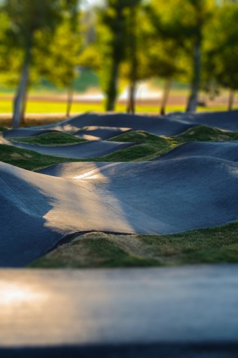 The proposed pump track would be a connected system of rollers and banked turns for cyclists to ride with minimal pedaling, located next to the park’s parking lot.  (courtesy Pexels)