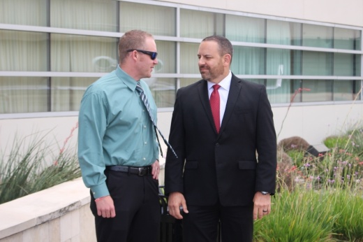 From left, Cypress Creek EMS Critical Care Manager Zach Dunlap and CEO Wren Nealy chat at the Million Air terminal at Hobby Airport before a June 30 contract signing between CCEMS and American Jet International. (Wesley Gardner/Community Impact Newspaper)