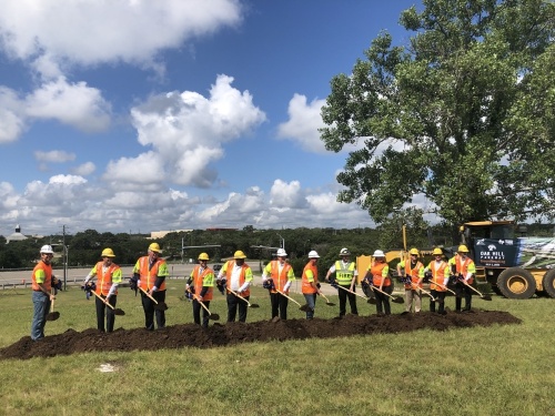 A group of officials breaks ground on the Oak Hill Parkway project. (Benton Graham/Community Impact Newspaper)