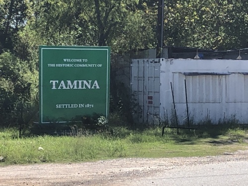 A sign marks the boundaries of the unincorporated Tamina community. (Andrew Christman/Community Impact Newspaper)