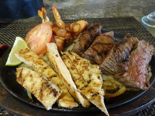 Fajitas come with an assortment of meats to choose from, such as shrimp, chicken, or beef with grilled onions. All fajitas are served with a side of rice and refried beans ($17-$46). (Emily Jaroszewski/Community Impact Newspaper)