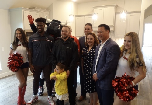 Operation Finally Home partnered with the Houston Texans to award Stephen Netzley (center) his new home. (Emily Jaroszewski/Community Impact Newspaper)