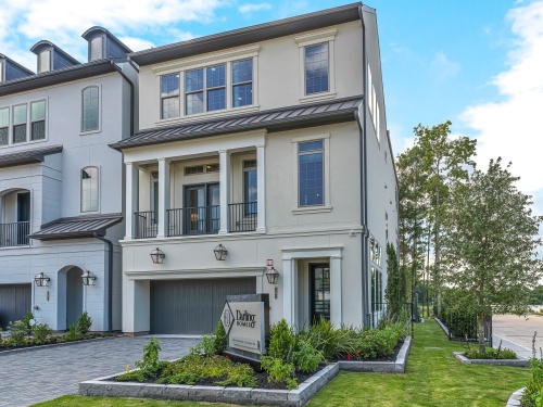 The three-story model home on Vue Cove Drive includes a front patio and a first-floor garage. Buyers can build from a range of three-story and four-story townhome models. (Photos courtesy Taylor Morrison)