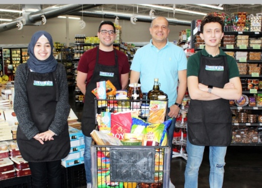 Blue Fig International Market is increasing its inventory to appeal to more people. From left is cashier Alaa Alzarrad, owners Walid Radwan and Ziad Nowar, and store manager Ahmad Nasrallah. (Karen Chaney/Community Impact Newspaper)