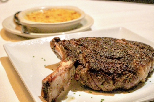 The 27 oz. Snake River ribeye (40) paired with cream corn (2) is a chef recommended menu item. (Andrew Christman/Community Impact Newspaper)