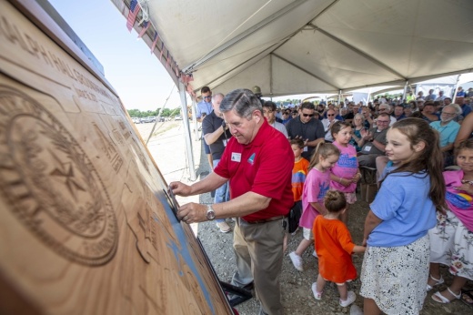 man with crowd behind him