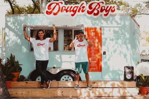 Photo of two men outside a food truck