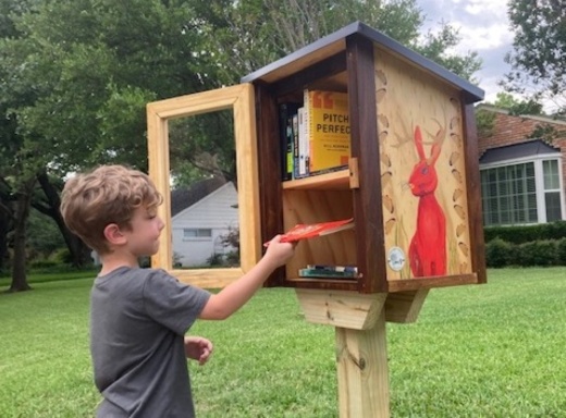 Child at a Little Free Library.