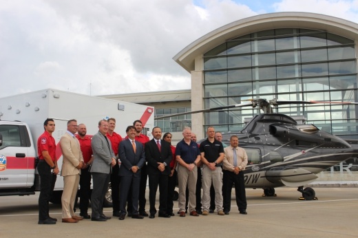 Cypress Creek EMS and American Jet International officials celebrate the beginning of their new partnership at Million Air terminal at Hobby Airport. (Wesley Gardner/Community Impact Newspaper)