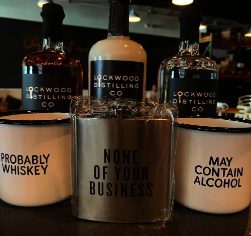 Alcohol-related merchandise, such as these flasks and cups, are sold in the new retail market at Lockwood Distilling Co. (Courtesy Lockwood Distilling Co.)