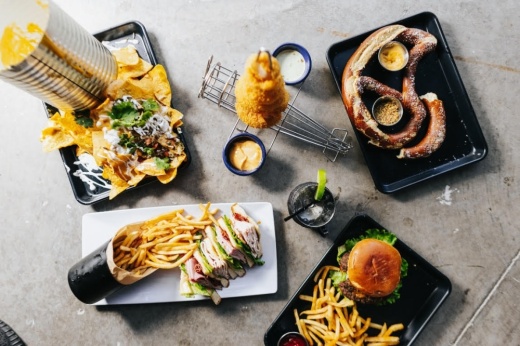 Ace's Sports Hangar menu includes a variety of shareable appetizers and American-style grill options, such as nachos, burgers, wings, and chicken and waffles. (Courtesy Kathy Tran)