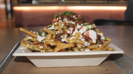 The garlic lobster fries include bacon, garlic, cotija cheese, parsley and house sauce over fries.(Erick Pirayesh/Community Impact Newspaper)
