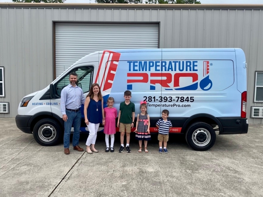 Temperature Pro Kingwood-Atascocita owner Will Bond stands with his family in front of a work van after expanding the HVAC franchise to Kingwood. (Courtesy of Temperature Pro Kingwood-Atascocita)