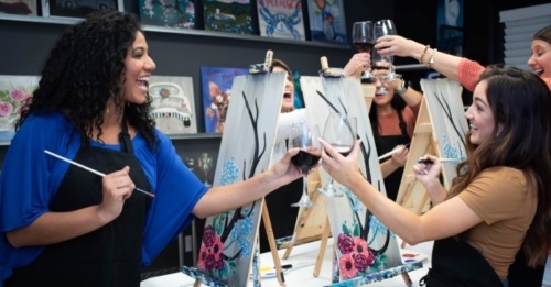 Women paining and clinking wine glasses