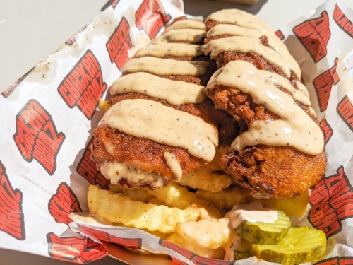 Stripper Chicks ($15): Texas toast is topped with hot chicken, pickles and Scooter Sauce in this dish. (Jishnu Nair/Community Impact Newspaper)