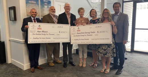 The Nelson Family Foundation presented donation checks for $125,000 each to the Round Rock Area Serving Center and Hope Alliance. (Brooke Sjoberg/Community Impact Newspaper)
