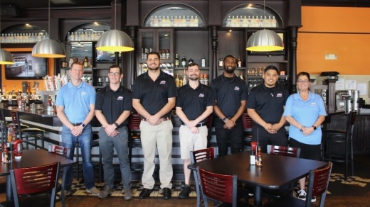 From left, District Manager Mike Akers; General Manager Matthew Sikes; managers Auston Weiss, Robert Westmoreland, Chris McEwen and Christian Galvan; and Kendra Shier, vice president of operations for eight Jakes locations, help run the Frisco location. (Miranda Jaimes/Community Impact Newspaper)