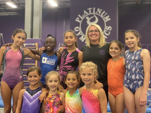 Addyson Martinez (third from right) helps guide young gymnasts daily at her Pflugerville academy. (Photos by Brian Rash/Community Impact Newspaper)