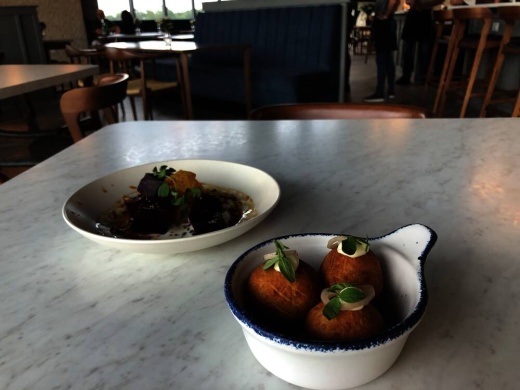 Le Vacher's most popular appetizer are fried dessert-like balls with Emmenthaler cheese, roasted garlic aioli and pickled shallot. (Community Impact Newspaper/Maggie Quinlan)