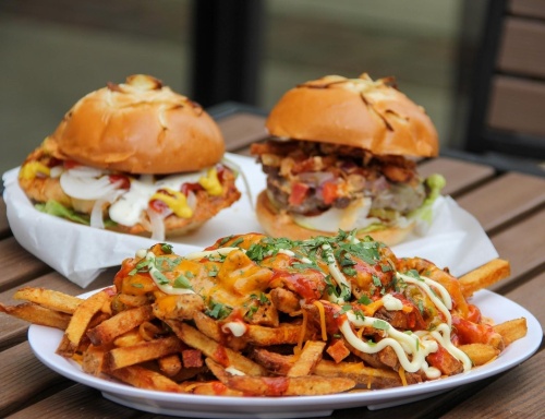 The restaurant will offer a variety of burgers, chicken sandwiches, wings, Philly cheesesteaks, salads, wraps, tacos, hot dogs and loaded fries for lunch and dinner. (Courtesy OMG! Burger)