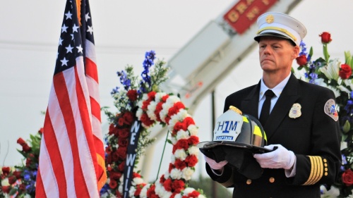 Assistant Fire Chief of Support John Sherwood holds a hazmat helmet from one of the New York Fire Department victims who lost their life on Sept. 11, 2001. (Sandra Sadek/Community Impact Newspaper)