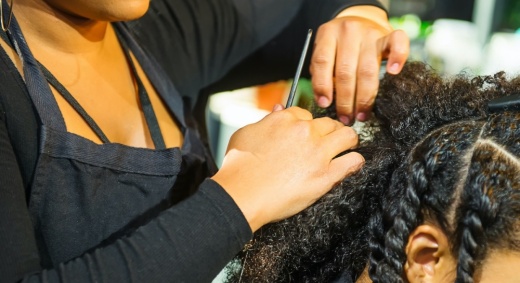 Woman braiding hair.