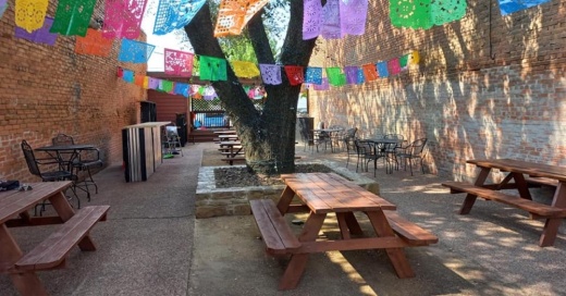 Mexican restaurant with colorful flags outside.