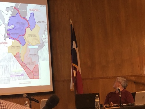 Dripping Springs Mayor Bill Foulds turns to view a map of the proposed Double L Ranch development at a Sept. 21 City Council meeting. (Maggie Quinlan/Community Impact Newspaper)