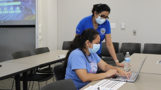 Dr. Amardeep Gill, professor of Population Focused Community Health, assists nursing student Thania Colocho with an assignment in the Health Sciences Center at Collin College's McKinney campus. (Brooklynn Cooper/Community Impact Newspaper)