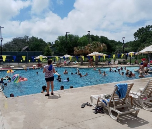 Visitors of all ages enjoy Hollywood Park's public swimming pool at Voigt Park on July 4, 2021. The town of Hollywood Park wants new rules and greater enforcement of user policy at the pool and elsewhere at the park. (Edmond Ortiz/Community Impact Newspaper)