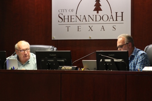 Council members Charlie Bradt (left) and Ted Fletcher (right) discuss asking the city's municipal development district for additional funding during a Sept. 22 meeting. (Andrew Christman/Community Impact Newspaper)