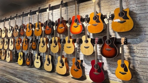 wall of hanging guitars