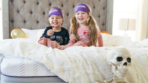 kids smiling on bed