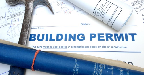 building permits on desk with hammer